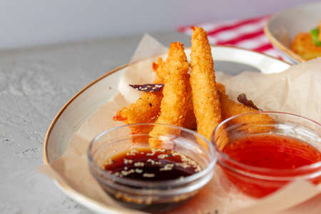 Deep fried shrimps served with sauce on plateの写真素材