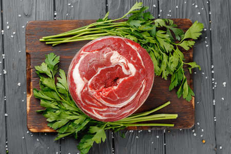 Raw beef fillet steaks on black wooden tableの写真素材