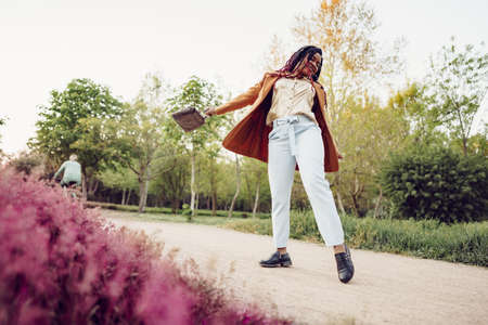 Young african american woman having a walk in a parkの写真素材