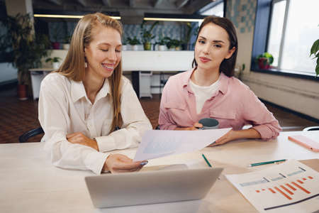 Two women entrepreneurs working together in officeの写真素材