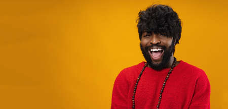 Portrait of smiling young black man in studio