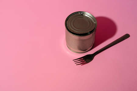 Canned food tin on pink studio background