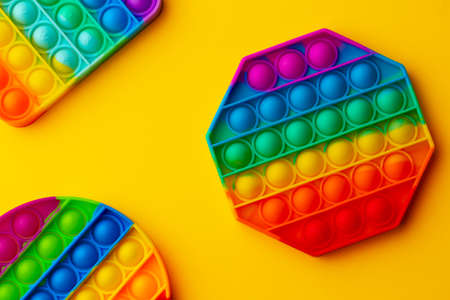 Colorful antistress pop it toy on yellow backgroundの写真素材