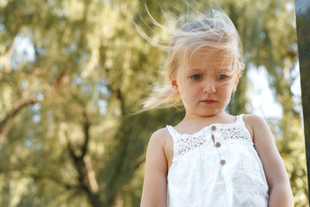 Close up portrait of a little blonde girl on a summer dayの写真素材