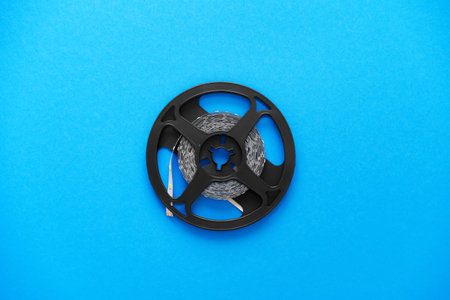 Metal detector coil on blue background, top view