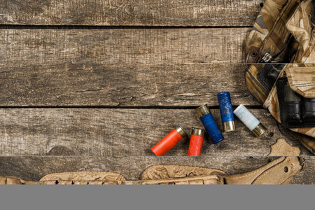 Various hunting equipment on old wooden background