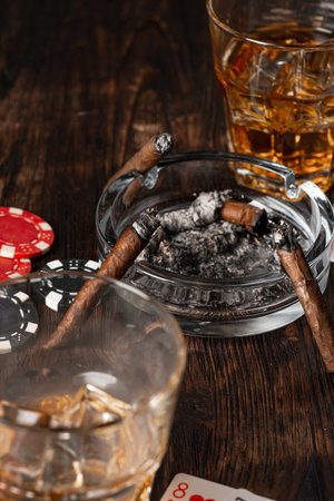 Playing poker with whiskey and cigars on tableの写真素材