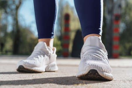 Feet of a woman dressed in sportswear and sneakers for runningの写真素材