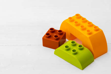 Toy building kit details on wooden background