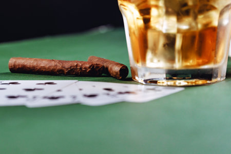 Cigar and playing cards on casino tableの写真素材