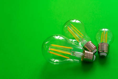 Light bulb on green paper background close upの写真素材