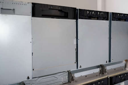 Row of new dishwashers in home appliances shop
