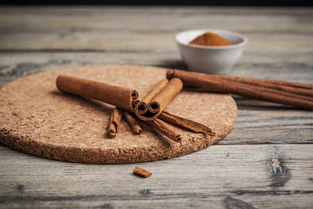 Cinnamon sticks on wooden background.