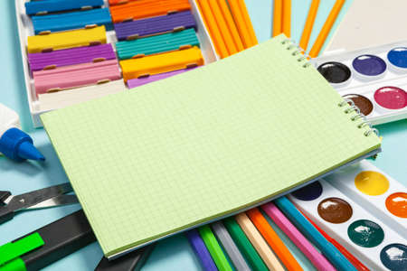 school supplies at abstract colorful background texture