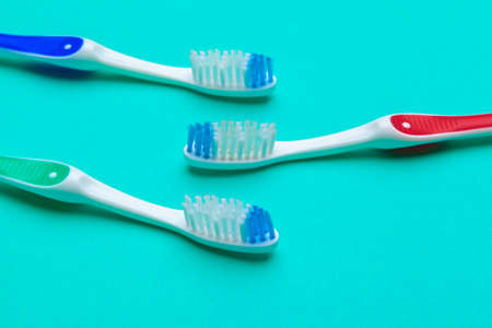 Flat lay composition with manual toothbrushes on color background, close up