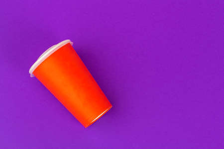 Takeaway cup of coffee on bright colored backgroundの写真素材