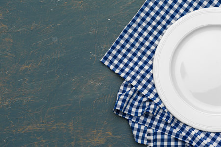Empty plate and towel over wooden table background.の写真素材
