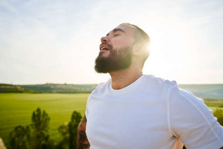 Young bearded man portrait outdoors in the mountainsの写真素材