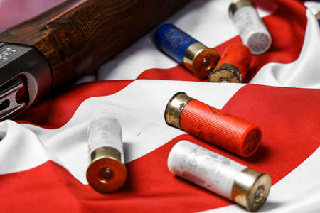 Automatic rifle on USA flag on wooden background