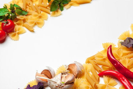 Pasta Spaghetti with ingredients for cooking pasta on a white background, top view.の写真素材