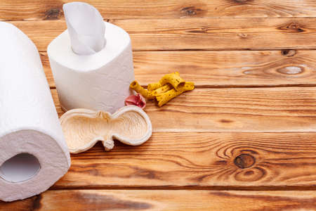 Toilet paper roll close up on wooden background