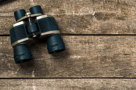 Hunting equipment binoculars on wooden background close upの写真素材