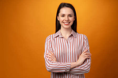 Portrait of young smiling brunette woman in studioの写真素材