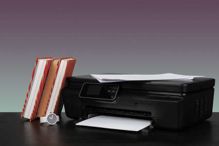 Compact home laser printer against gray background