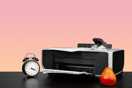 Compact home laser printer against pink background