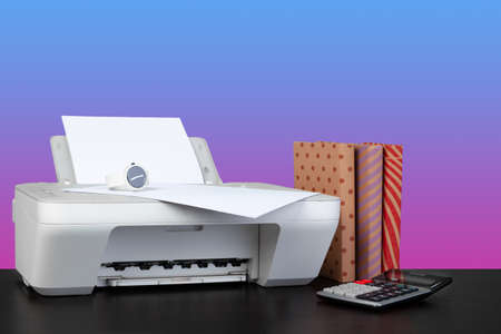 Home laser printer on desk against purple backgroundの写真素材