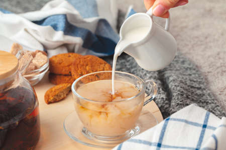 Hot masala chai, tea with milk poured over close up