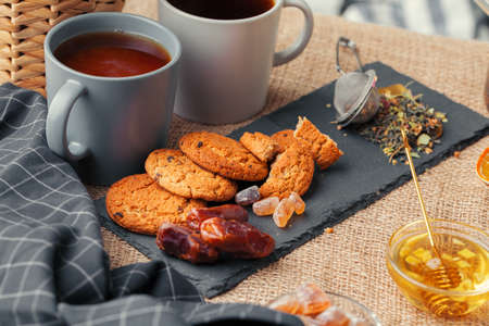 Tea with cookies on sackcloth background close up
