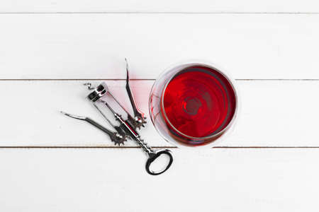 Goblet of red wine on wooden table on wooden wall backgroundの写真素材