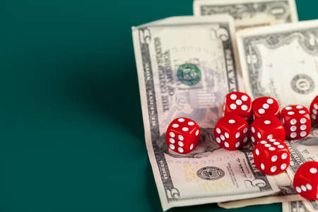 Playing Dices and Stack of American Dollars Bills.