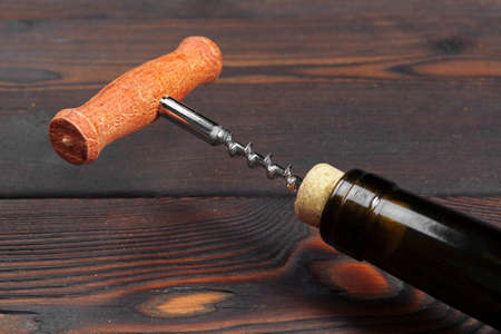 Bottle opener close-up, on wooden backgroundの写真素材
