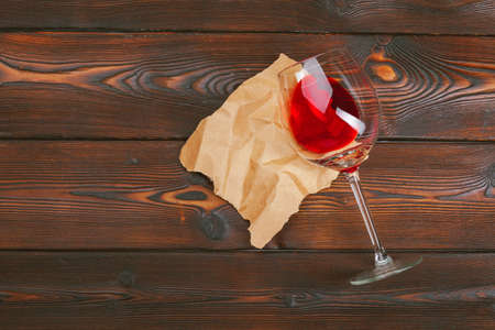 Goblet of red wine on wooden table on wooden wall backgroundの写真素材