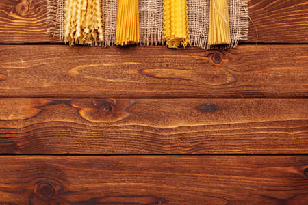 dried pasta on wooden background
