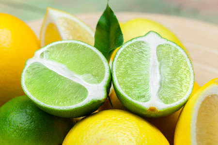 lemons and limes on a wooden background.の写真素材
