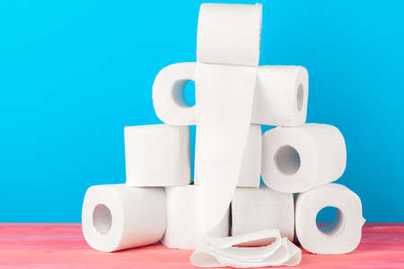 Toilet paper stack on bright blue background