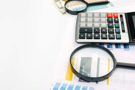 Business graph with magnifying glass on tableの写真素材