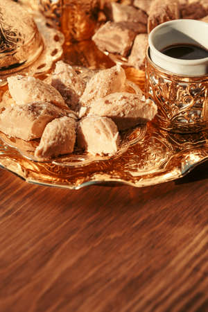 Turkish sweets with coffee on a wooden table