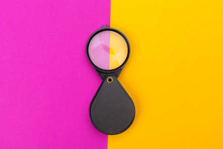 magnifying glass on yellow backgroundの写真素材