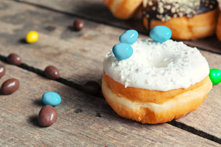 Glazed donuts on wooden background