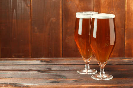 Glass beer on wood background