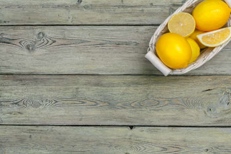 fresh lemons on wooden table.の写真素材
