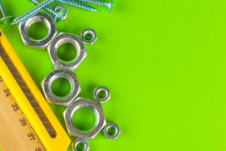 Engineering tools. Bolts and nuts on green backgroundの写真素材
