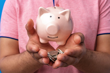 Close up of male hands holding piggy bank
