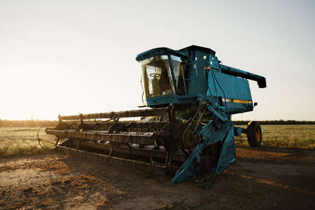 Blue combine harvester agriculture machine harvesting in a fieldの写真素材