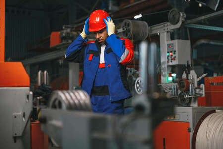 Portrait of african american male handyman working in an industrial factory