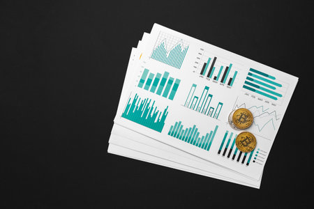 Bitcoin coin on stock market charts papersの写真素材
